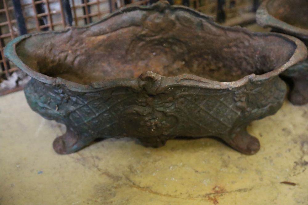 A pair of late 19th century French cast iron oval urns, width 49cm